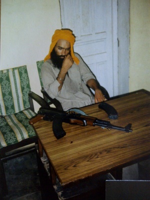 Shaheed Surinder Singh Shinder - Sitting Down AK47.jpg